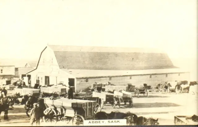 Wagons and horses outside a large barn, Abbey